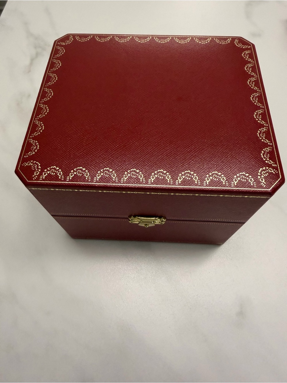 Cartier red jewelry box with gold accents